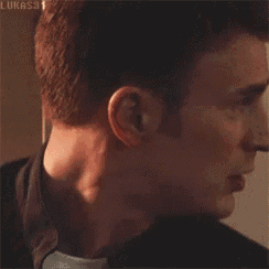 a close up of a man 's face with his mouth open and his tongue sticking out .