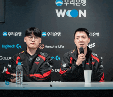 two men sitting at a table with a sign that says won