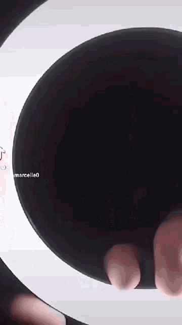 a person 's feet sticking out of a hole in a black circle