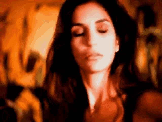 a blurry picture of a woman with her eyes closed .