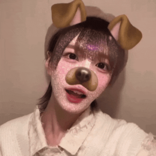 a girl with a dog mask on her face taking a selfie