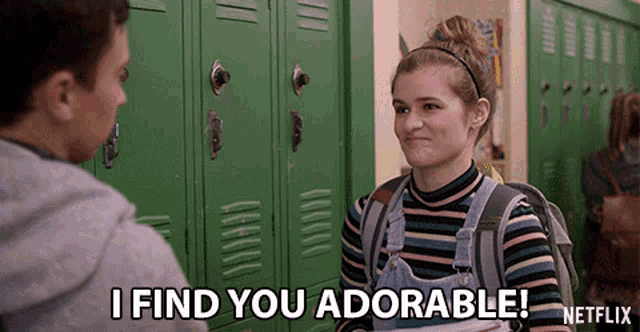 a girl is talking to a boy in a hallway and says i find you adorable netflix