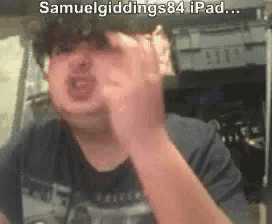 a man is making a funny face while wearing glasses and a shirt that says samuelgiddings84 ipad