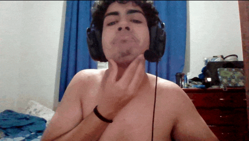 a shirtless man wearing headphones and a black wristband