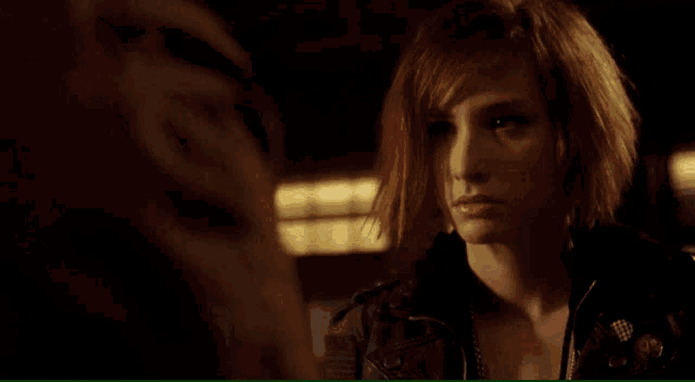 a woman with red hair looks at another woman