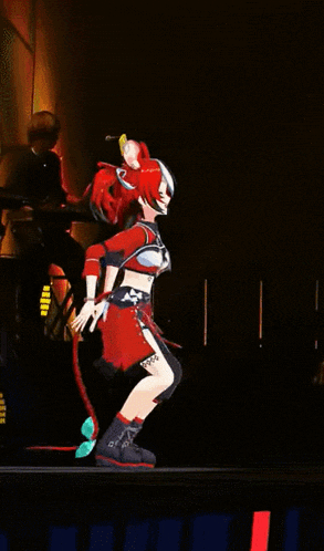 a woman in a red costume is dancing on a stage in front of a microphone .