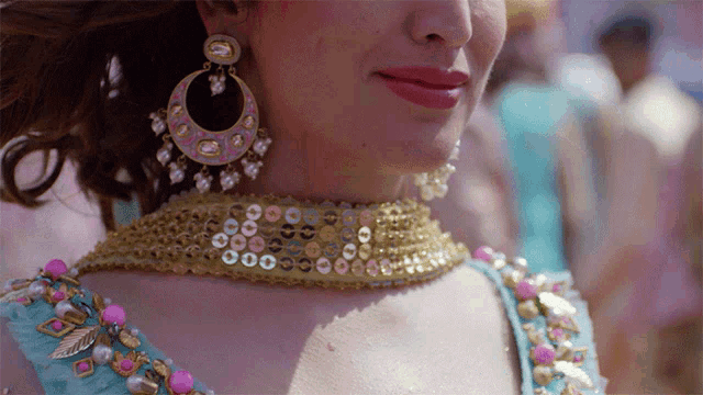 a close up of a woman wearing earrings and a choker necklace