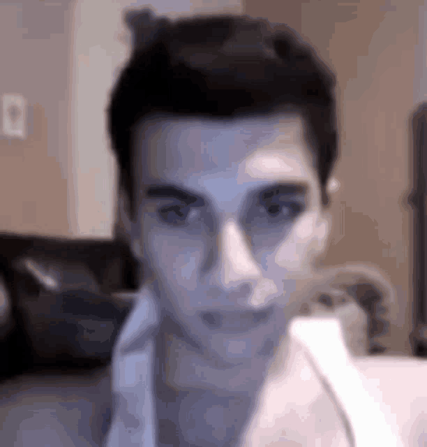 a young man is taking a selfie in a living room .
