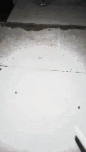 a dark room with a white tile floor