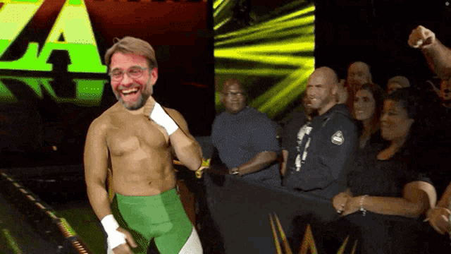a man in a wrestling outfit is standing in front of a crowd
