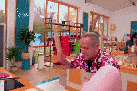 a man wearing an apron that says ' vist ' on it is holding a hammer