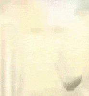 a blurred image of a person standing in front of a window .