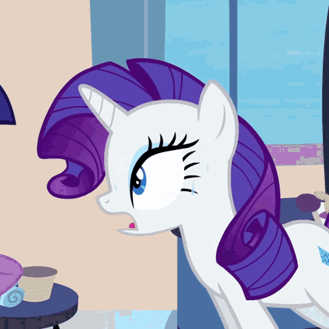 a white pony with a purple mane is standing in front of a window