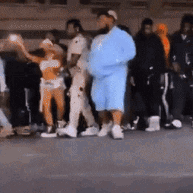 a blurry photo of a group of people standing on a street
