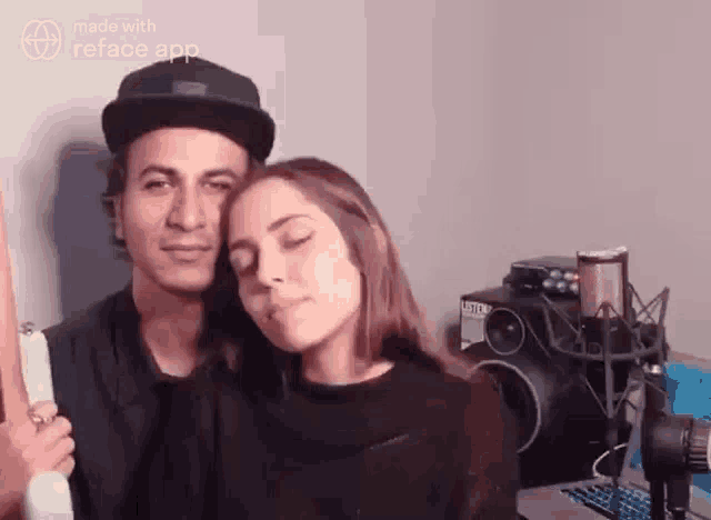 a man and a woman are standing next to each other in a room with a microphone .