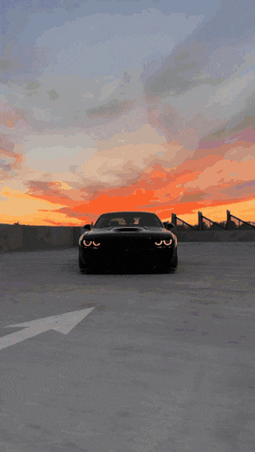 a car is parked in a parking lot at sunset