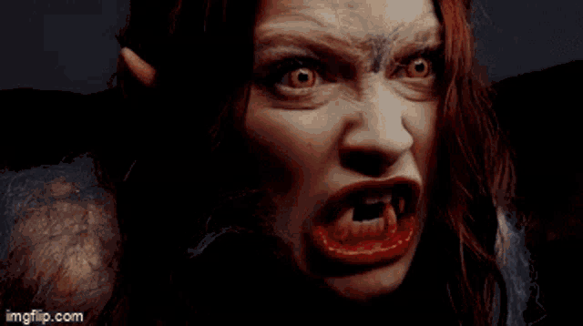 a close up of a woman 's face with fangs and the words imgflip.com on the bottom right