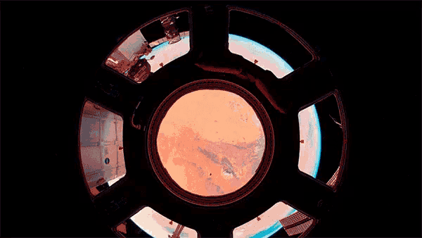 a view of the earth through a window on a space ship