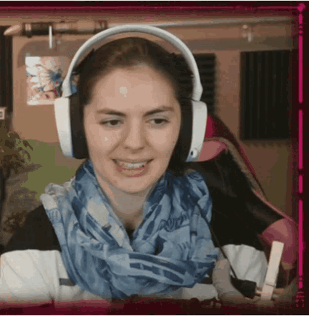 a woman wearing headphones and a scarf that says ' pink ' on it