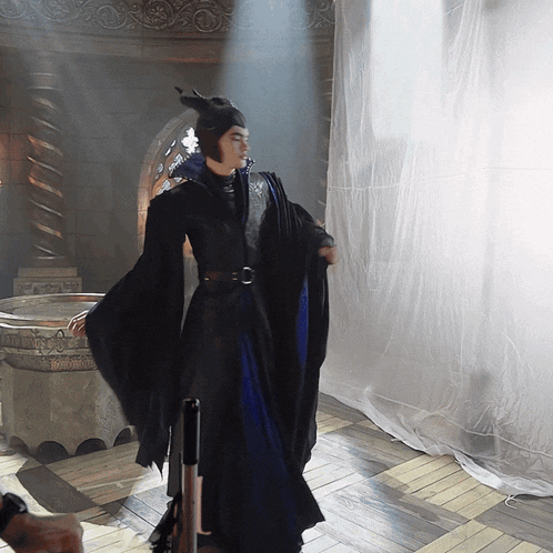 a woman in a costume with horns is standing in a room