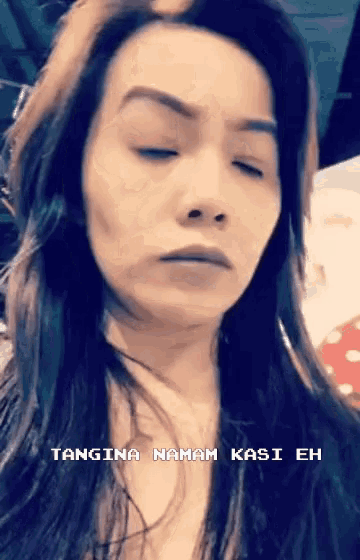 a close up of a woman 's face with the words tangina namam kasi eh written below her