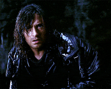 a man with wet hair is wearing a black jacket