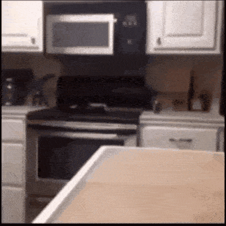 a kitchen with a stove a microwave and a counter top