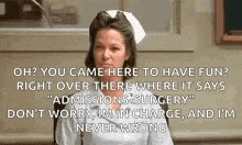 a nurse is sitting in a chair in a hospital with a quote on her face .