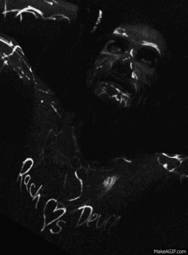 a black and white photo of a man with the words rock n ' roll written on his shirt