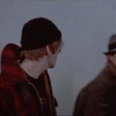 two men are standing next to each other wearing hats and glasses .