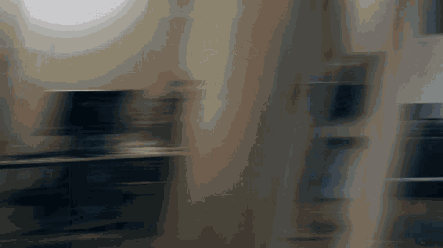 a blurred image of a person standing in a dark room