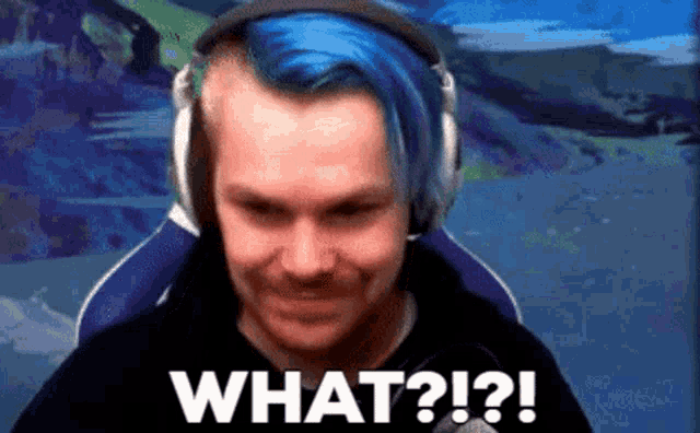 a man with blue hair is wearing headphones and says " what ? "