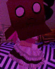 a red box with a pink face is sitting on a bed