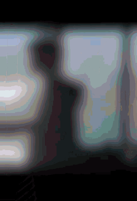 a blurred image of a person in a dark room