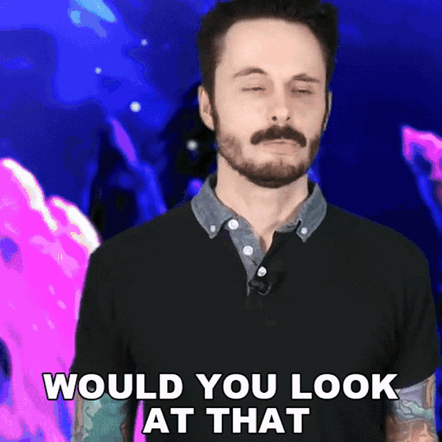 a man with a beard has his eyes closed and says would you look at that