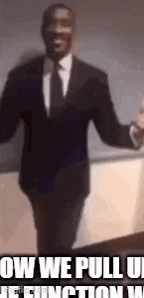 a man in a suit and tie is standing in front of a sign that says `` now we pull up the function '' .