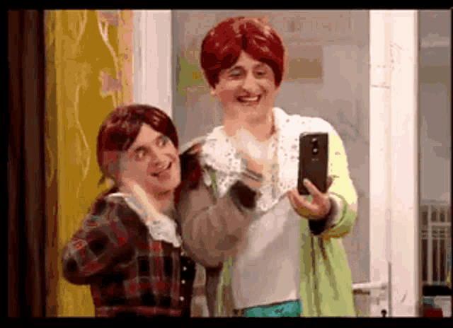 two people in wigs are taking a picture of themselves