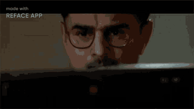 a man with glasses and a mustache is looking at a computer screen with the words `` times up '' written above him .