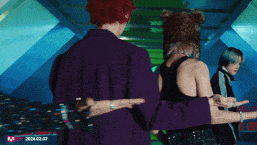 a group of people are standing in a room with the year 2024.02.07 on the bottom