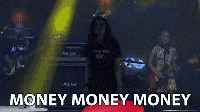 a group of people on a stage with the words money money money written on the bottom