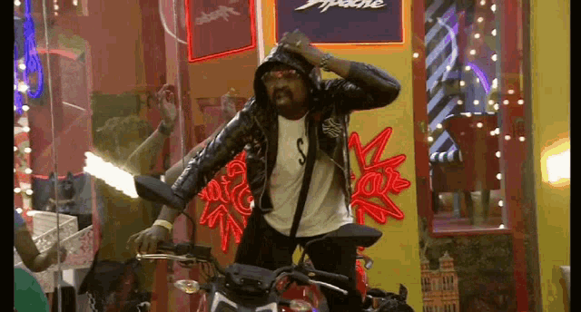 a man is riding a motorcycle in front of an apache sign