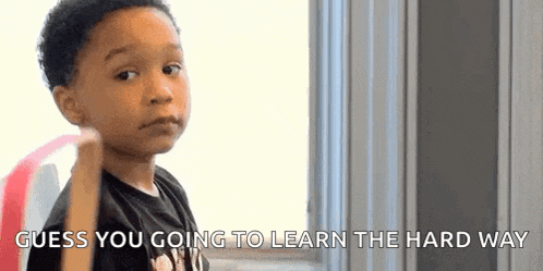 a young boy is looking at the camera with the words `` guess you going to learn the hard way '' written below him .