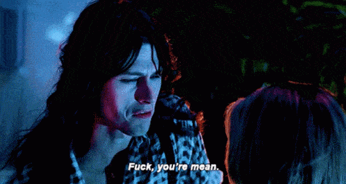 a man with long hair says " fuck you 're mean " to a woman