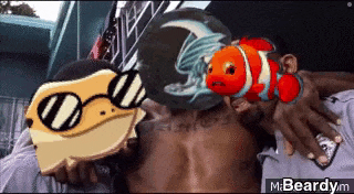 a man is holding a clown fish and a lizard on his back