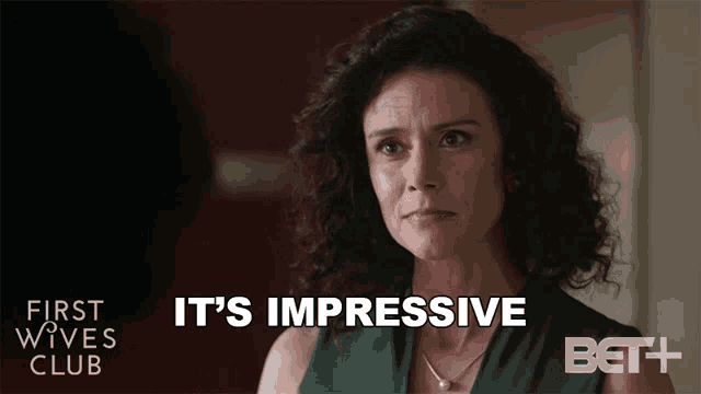 a woman says it 's impressive in front of a bet + logo