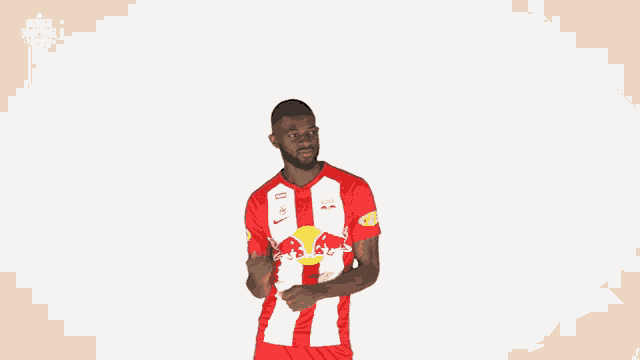 a man wearing a red and white jersey that says red bull on it