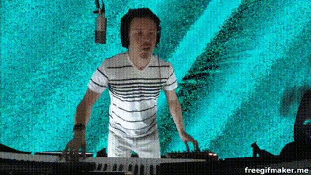 a man wearing headphones is playing a keyboard .