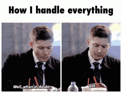 a man in a suit and tie is sitting at a table eating ice cream .