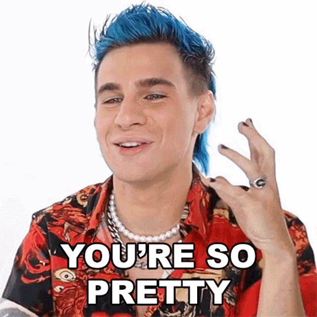 a man with blue hair is wearing a red shirt and a pearl necklace and says you 're so pretty