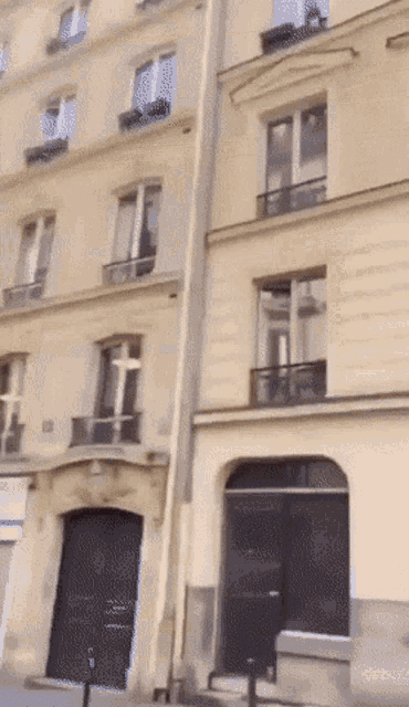 a very tall building with a black door and stairs